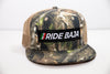 "Ride Baja Mexican Insurance" Rider Hat with Flag - Hybricam Camo Trucker Snapback
