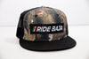 "Ride Baja Mexican Insurance" Rider Hat with Flag. - Hybricam Camo/Black